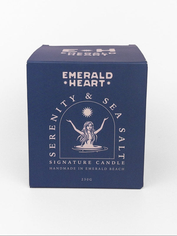 Emerald Heart 'Serenity & Seasalt' signature candle in a dark blue square box with white text and illustration, photographed on a clean white background.